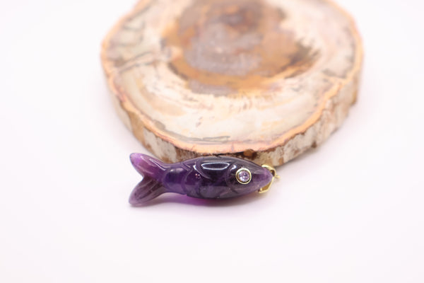 gold and amethyst carved fish pendant