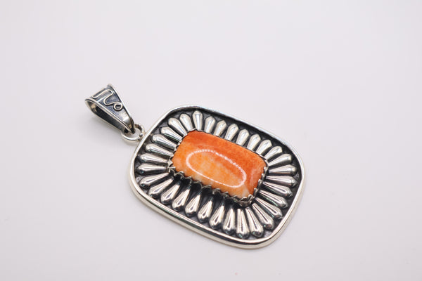 sterling silver pendant featuring a vibrant orange spiny oyster shell