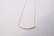 Curved textured 18k gold bar with adjustable sterling silver chain