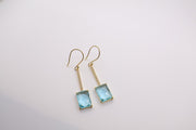 14K yellow gold drop earrings featuring emerald-cut