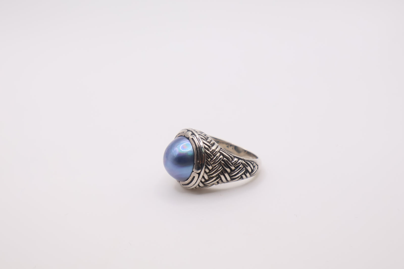 Bali Designs sterling silver ring featuring a round blue cultured mabe pearl set in an ornate, woven band