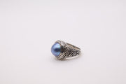 Bali Designs sterling silver ring featuring a round blue cultured mabe pearl set in an ornate, woven band