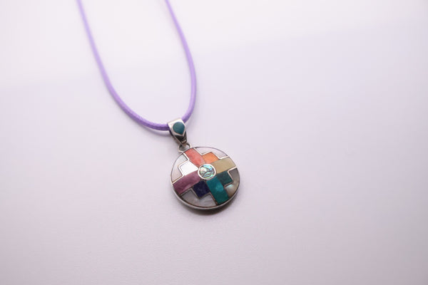 handmade Peruvian 950 silver Chakana pendant featuring a multi-colored stone and abalone inlay