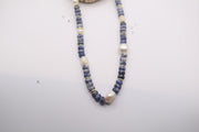 sodalite and pearl beaded necklace featuring blue gemstone beads, white freshwater pearls, and gold-colored spacer beads