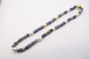 sodalite and pearl beaded necklace featuring blue gemstone beads, white freshwater pearls, and gold-colored spacer beads