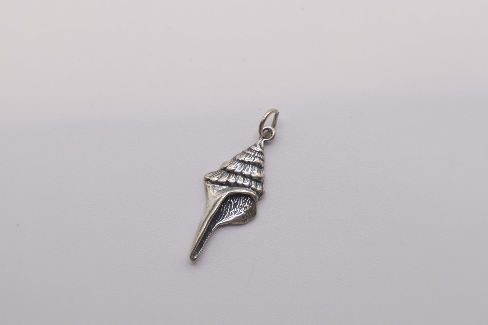 925 sterling silver conch shell charm with an oxidized finish