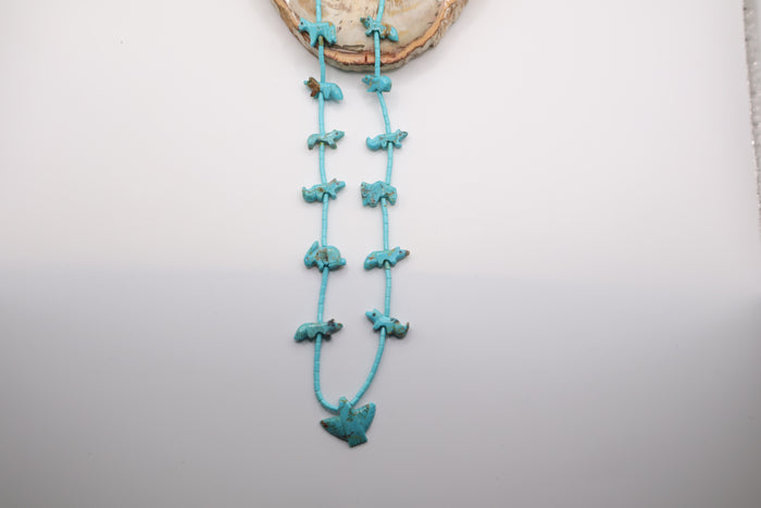 handcrafted Native American-style turquoise fetish necklace featuring hand-carved animal beads and a central eagle necklace