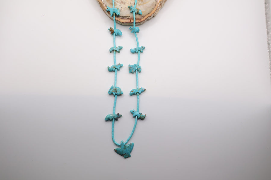 handcrafted Native American-style turquoise fetish necklace featuring hand-carved animal beads and a central eagle necklace