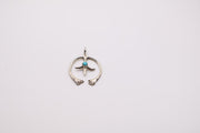 Native American Navajo sterling silver Naja pendant features a small turquoise stone at its center