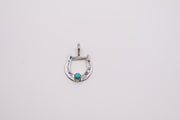 Native American sterling silver horseshoe pendant features a centered turquoise stone and often resembles handcrafted Navajo designs