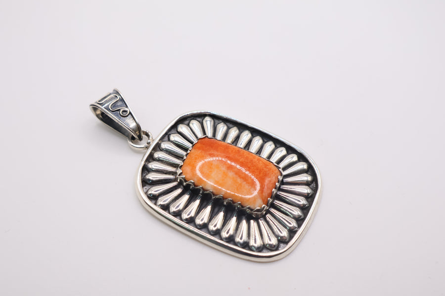 sterling silver pendant featuring a vibrant orange spiny oyster shell