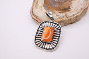 sterling silver pendant featuring a vibrant orange spiny oyster shell