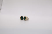 Sterling silver two-tone ring features a smooth oval green gemstone ring