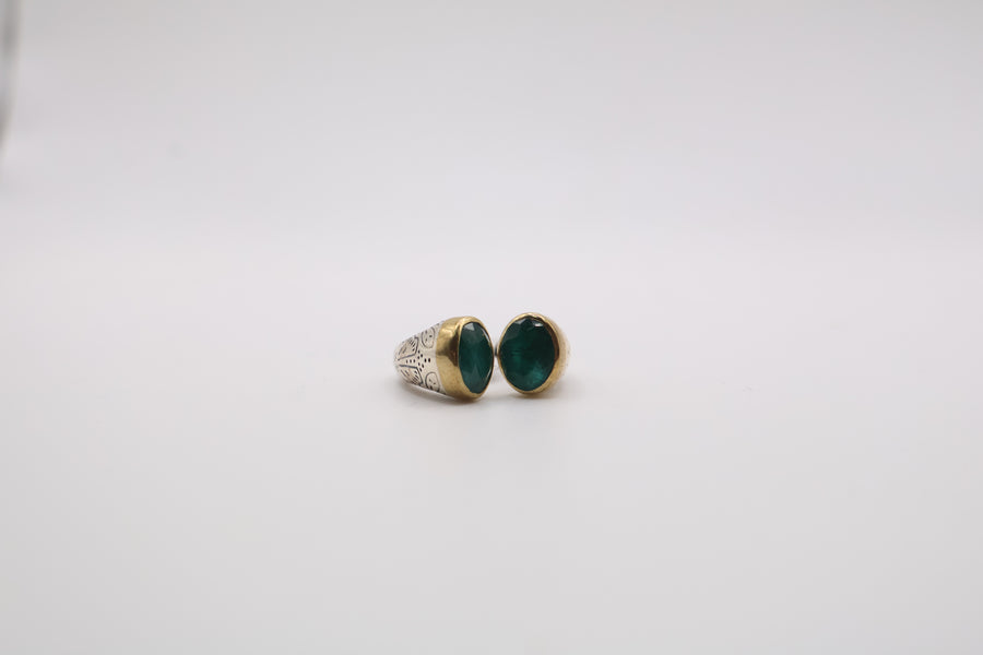 Sterling silver two-tone ring features a smooth oval green gemstone ring
