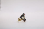 Sterling Silver open bypass ring featuring faceted natural red garnet stones and ornate scrollwork